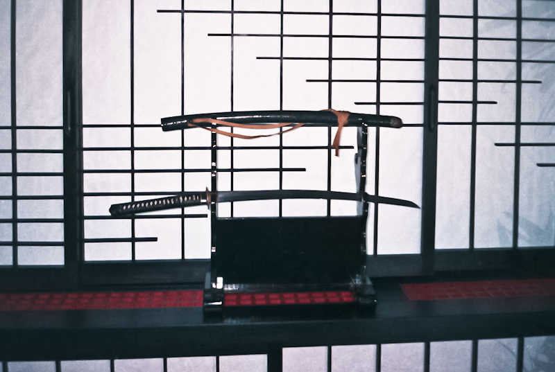 Japanese Sword aagainst a black Shoji wall 